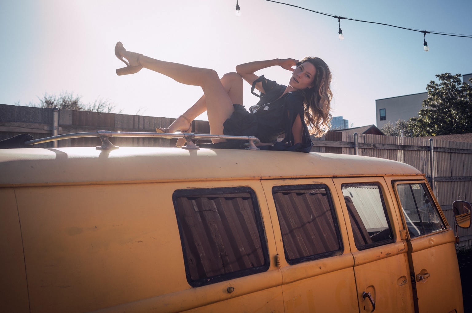 Golden light portrait on top of a yellow van